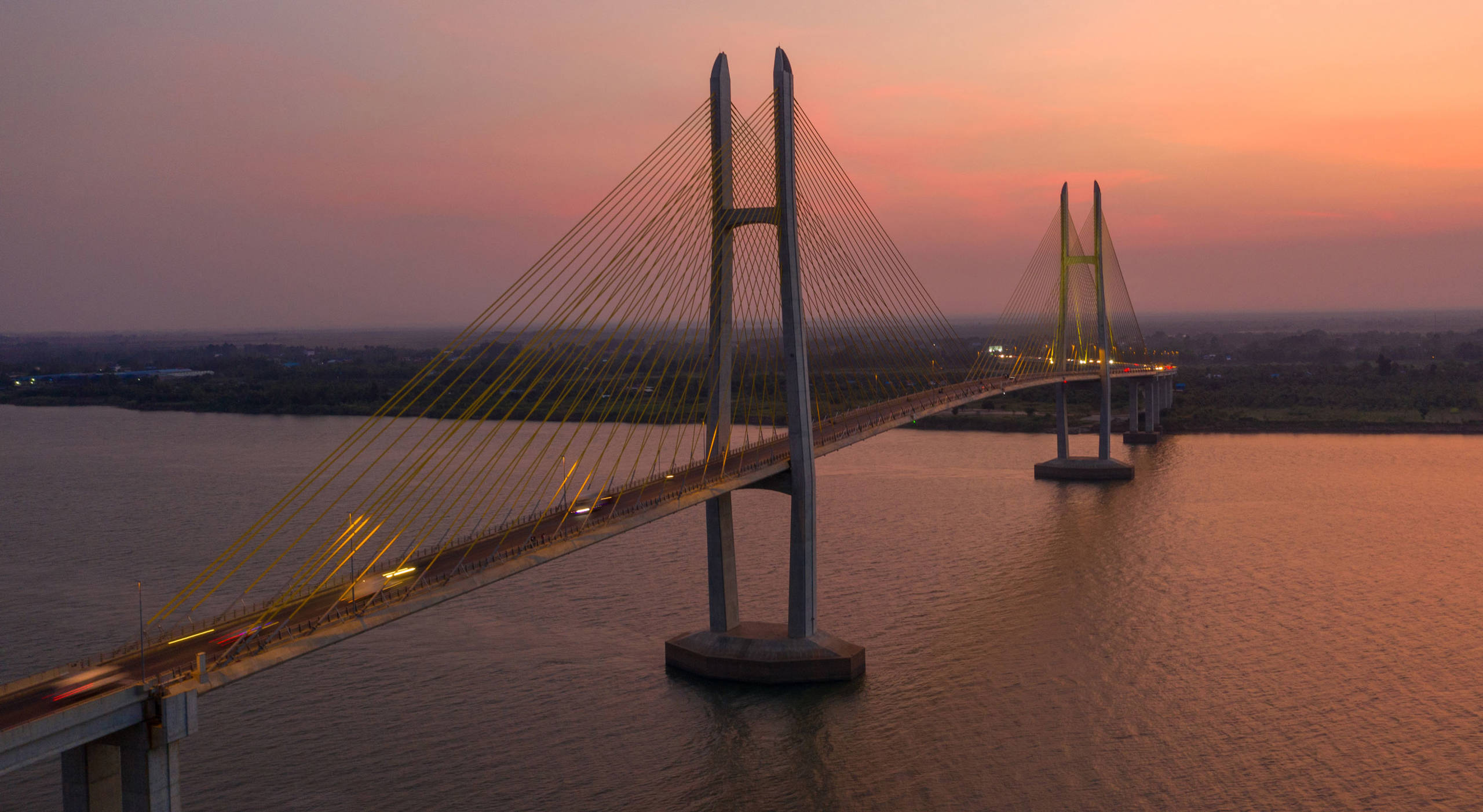 Long suspension bridge below the evening sky