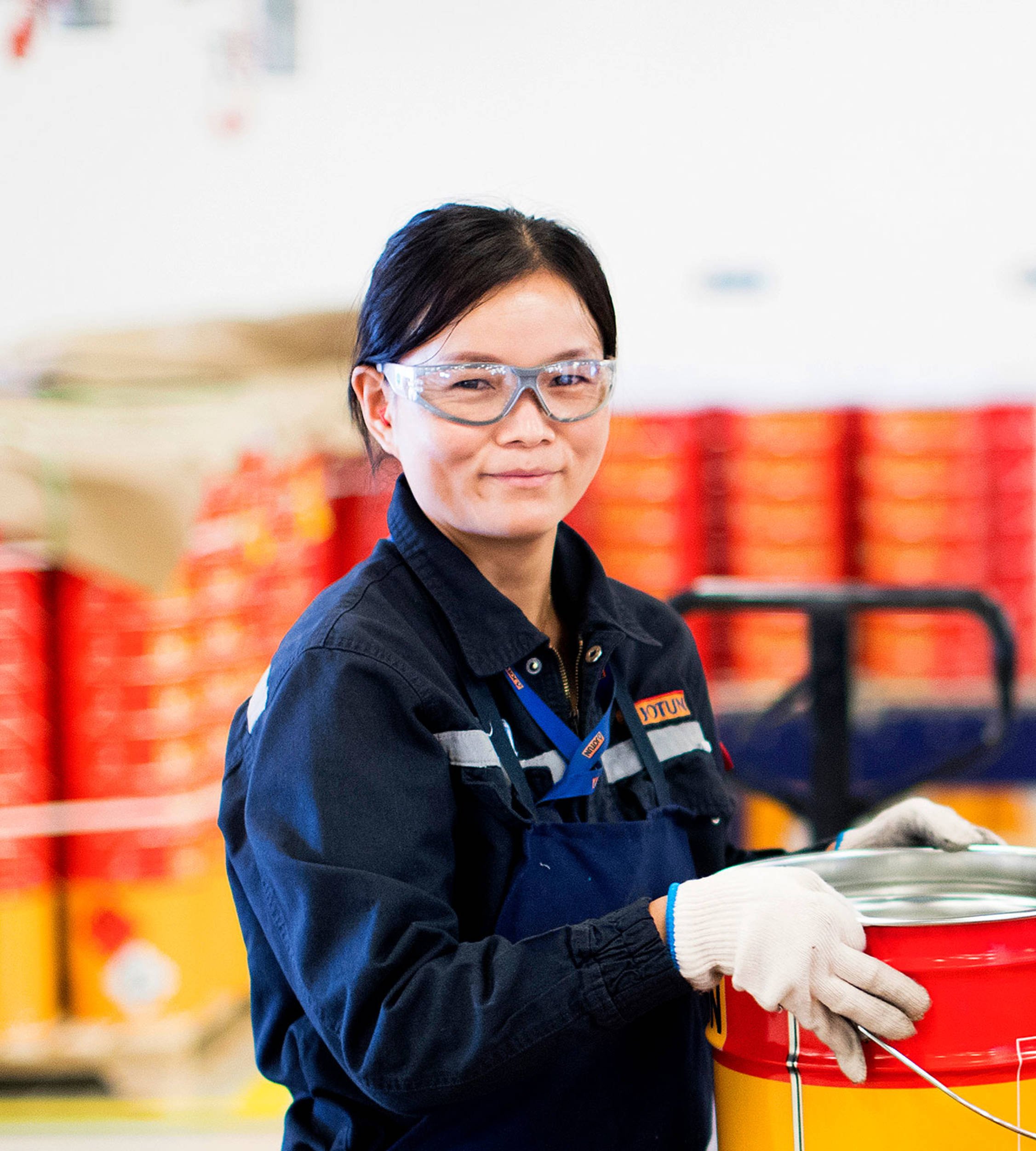 Female factory worker with a Jotun can