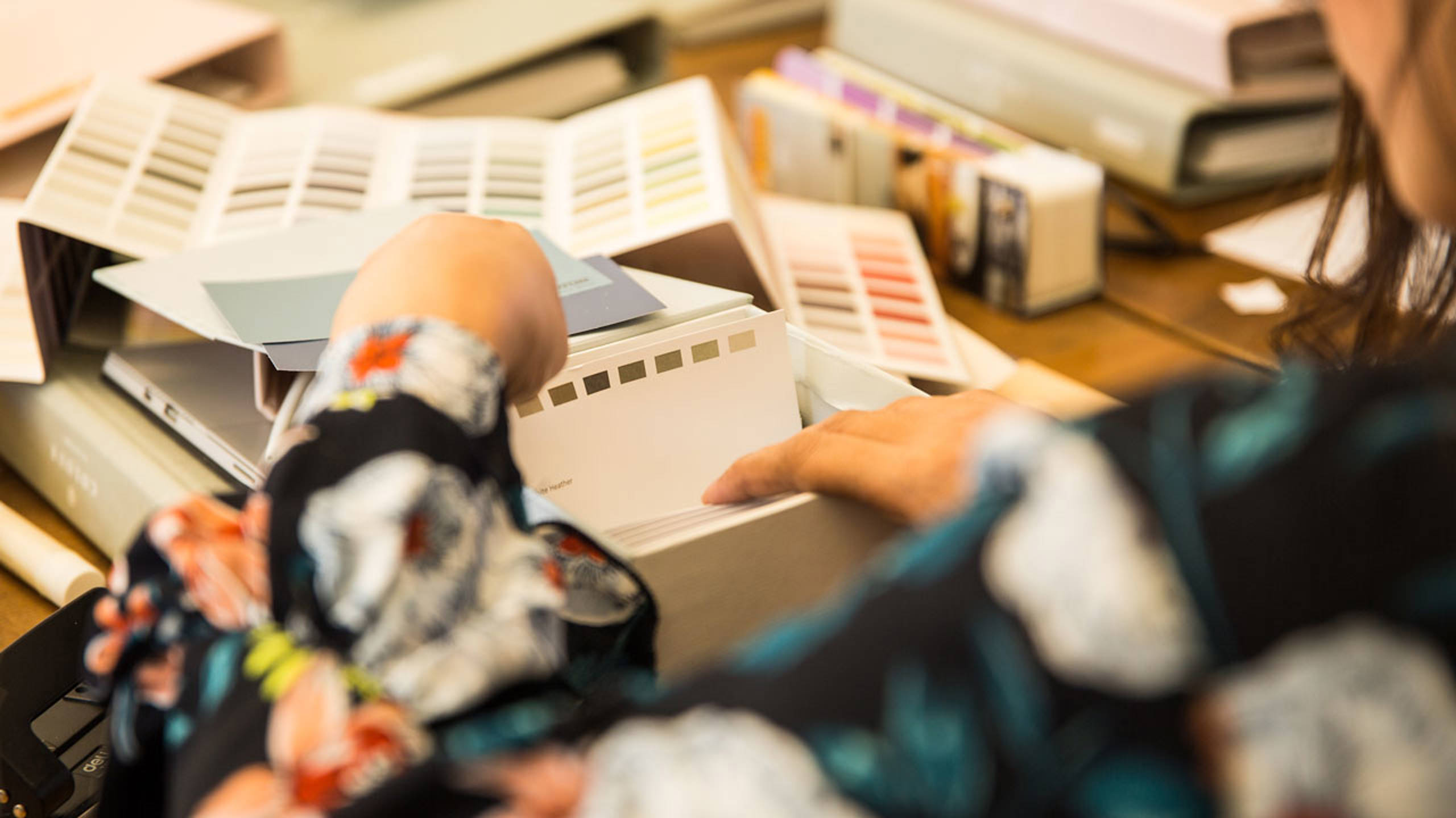 A person looking at colour samples at the Jotun Colour Academy